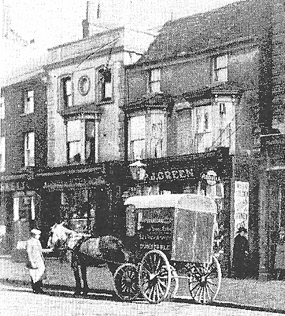 Photo of old store in high street sough with horse and cart out front.